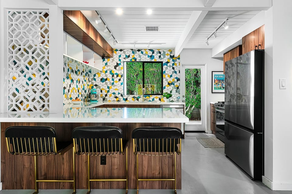 Fun and colorful kitchen with bar seating at the quartz peninsula