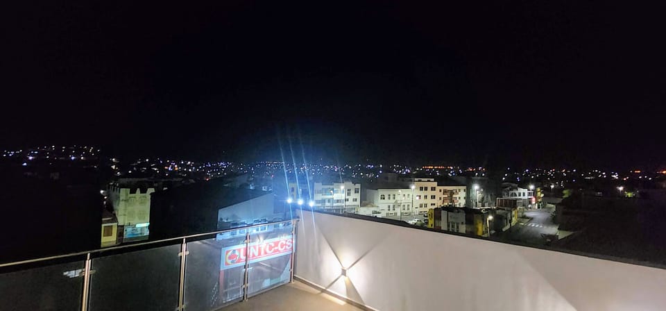Night time city view from shared top floor terrace