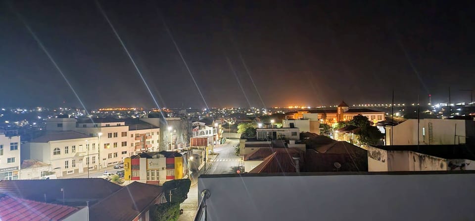 Nighttime city view from shared top floor terrace