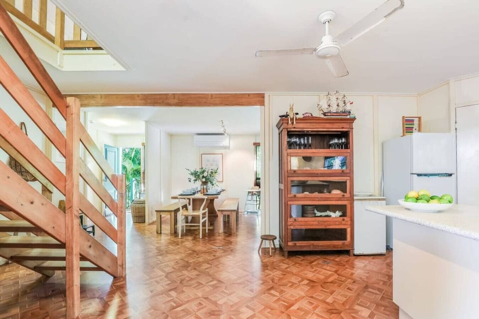 Kitchen + dining with timber flooring, rustic cabinetry, and coastal décor. Family‑friendly space with modern fittings and natural light.