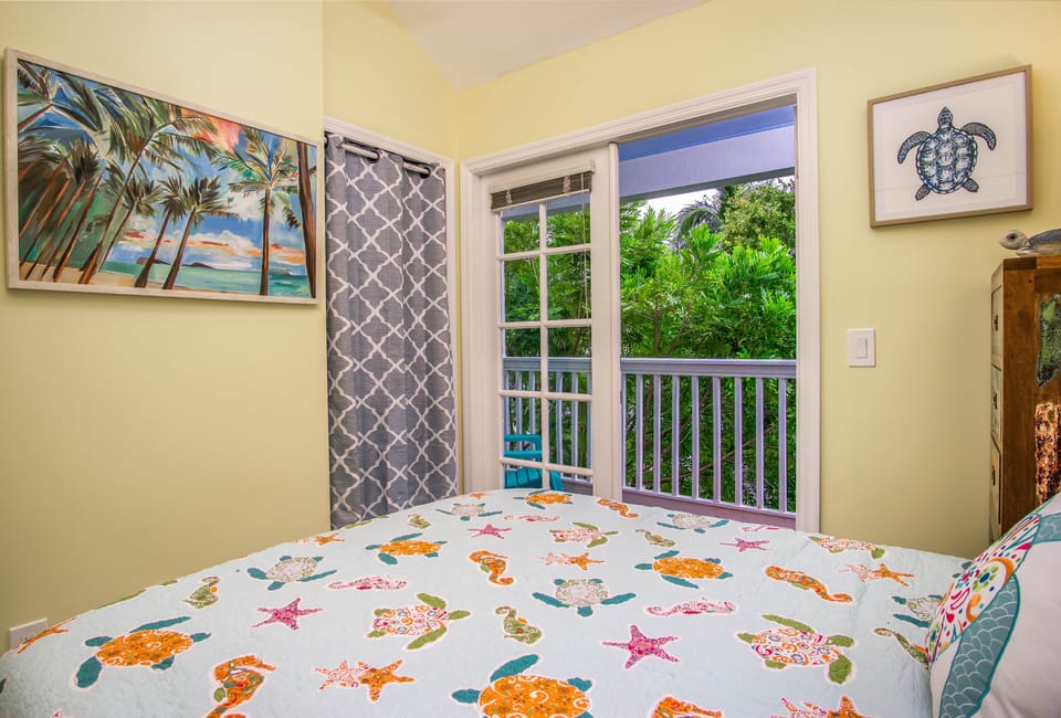 Guest Bedroom with French doors that open to the upstairs balcony. 