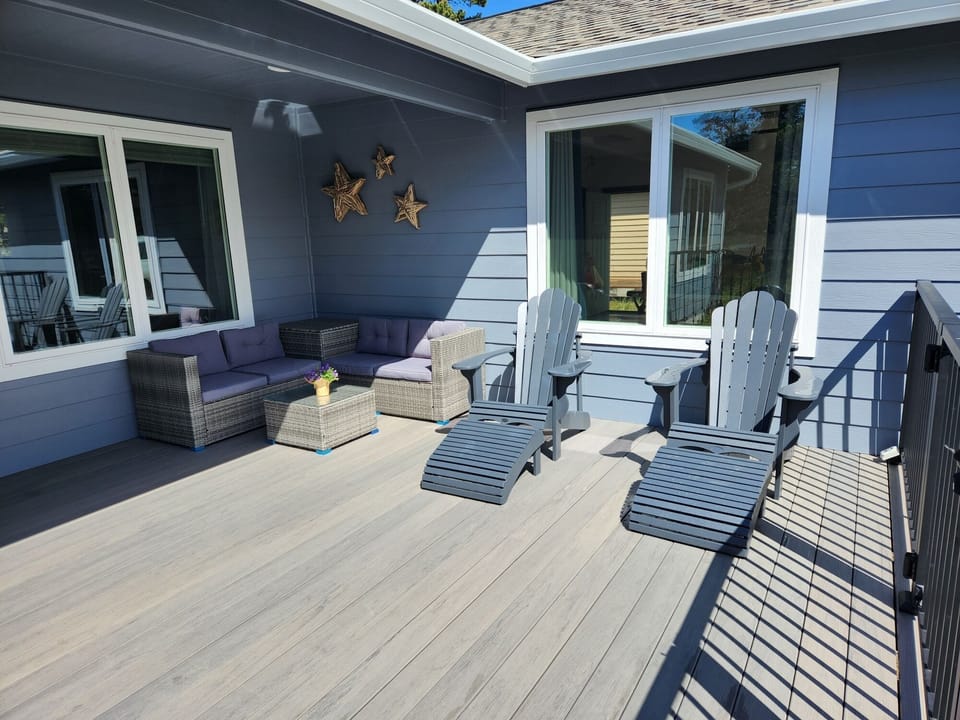 Partially covered front Deck w/Outdoor Sectional and Adirondack Chairs