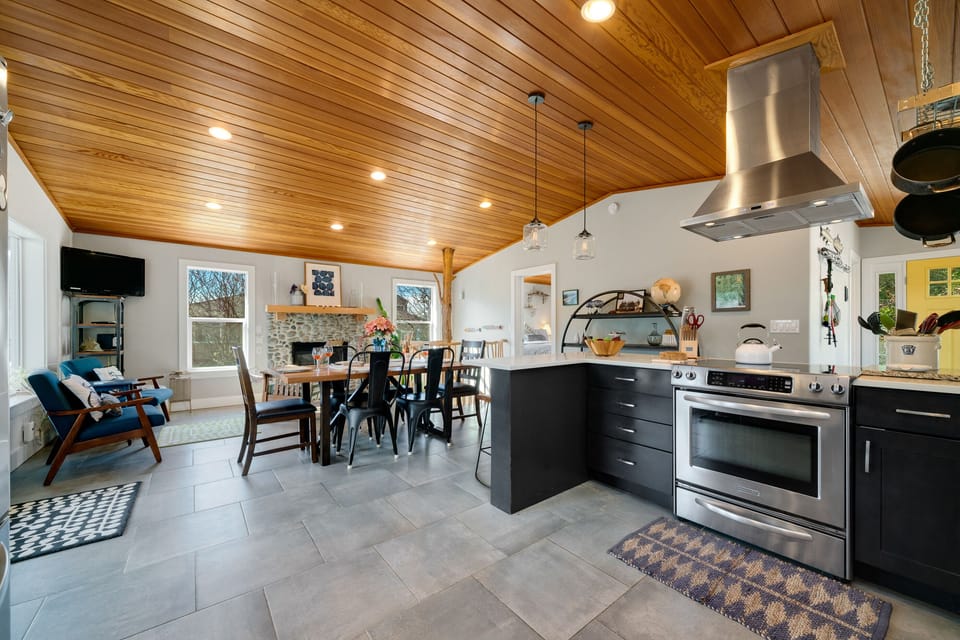 Open Floor plan with Fully equipped Kitchen, Dining table for 6 plus Bar seating. Open to the Living room with Streaming TV, Gas Fireplace, Access to upper deck.