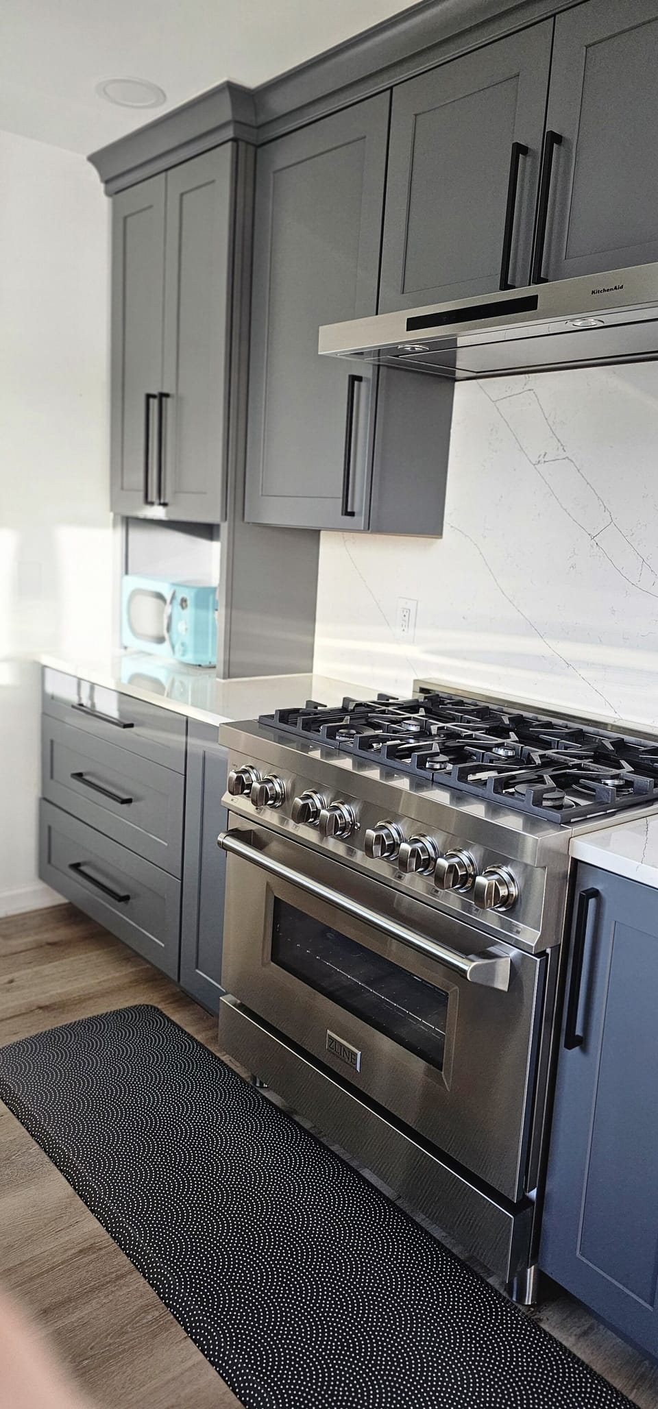 Close Up of 6-burner Gas Stove/Oven & Microwave; Quartz Countertops.