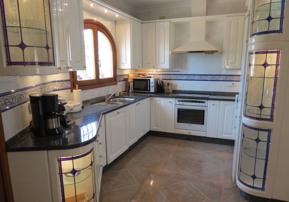 Fully equipped kitchen with modern appliances, ample counter space.