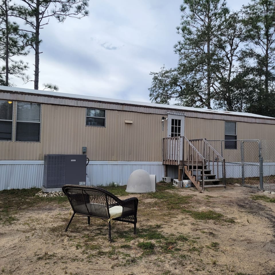 Rear of home with fenced yard if you are traveling with a dog