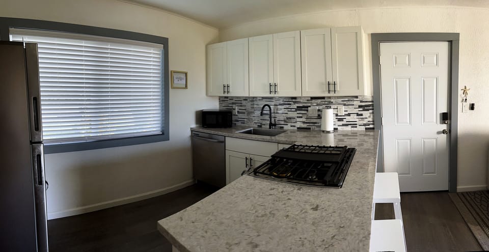 Large sized kitchen area with 5 burner gas range + oven. 