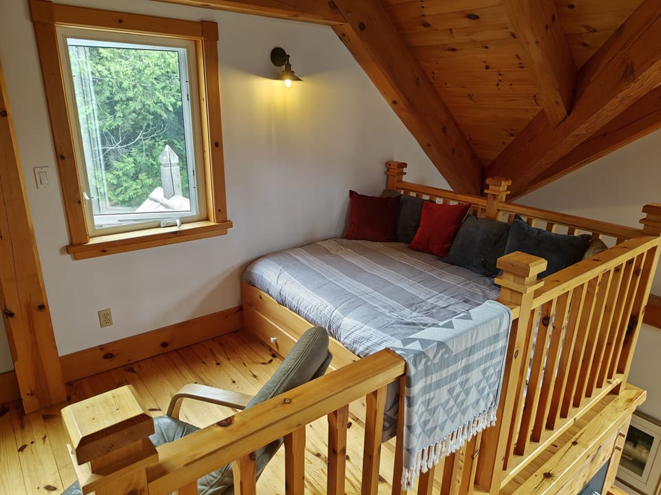 Double day bed in loft which is open to living room below