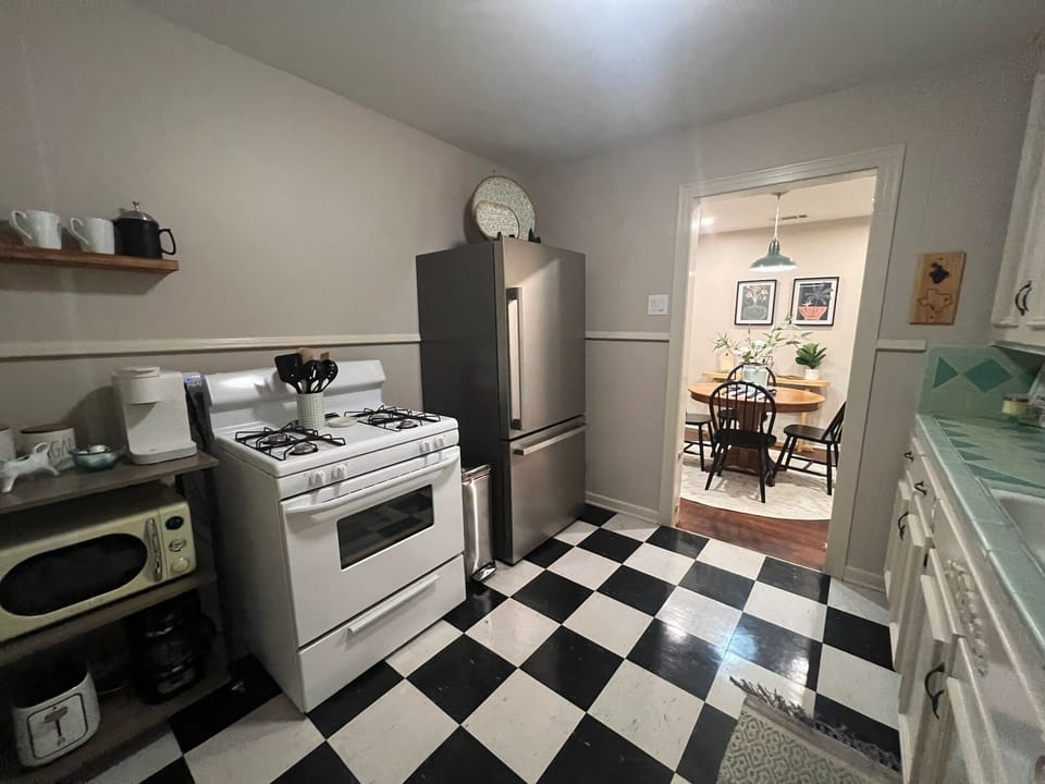 The charm remains in this kitchen with gas stove and brand new fridge. 