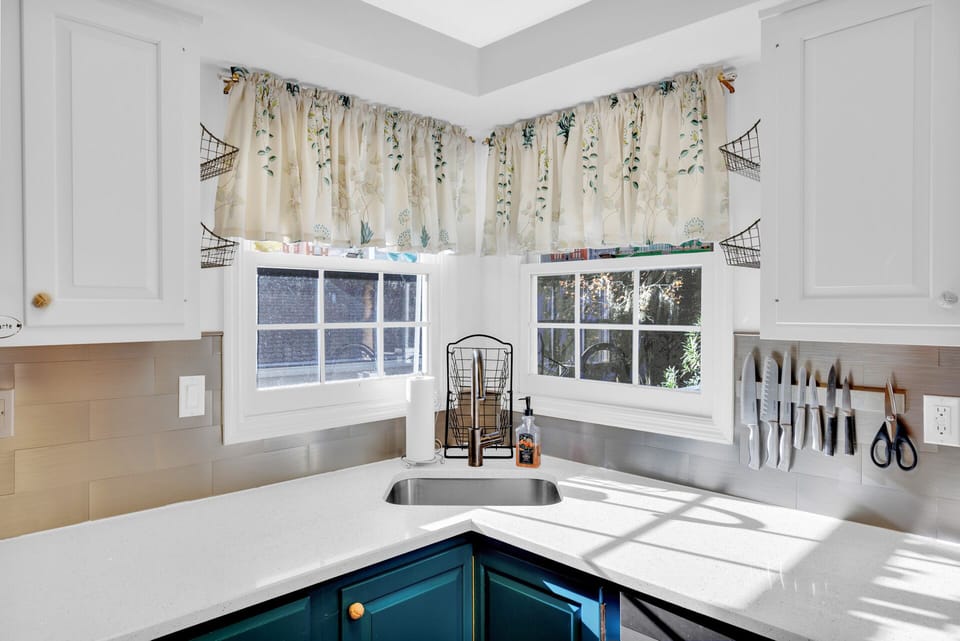 Fully stocked kitchen with stainless steel appliances.