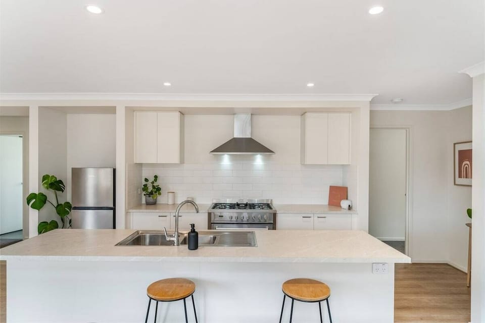 Fully-equipped kitchen with breakfast bar and all the amenities you need for a comfortable stay.