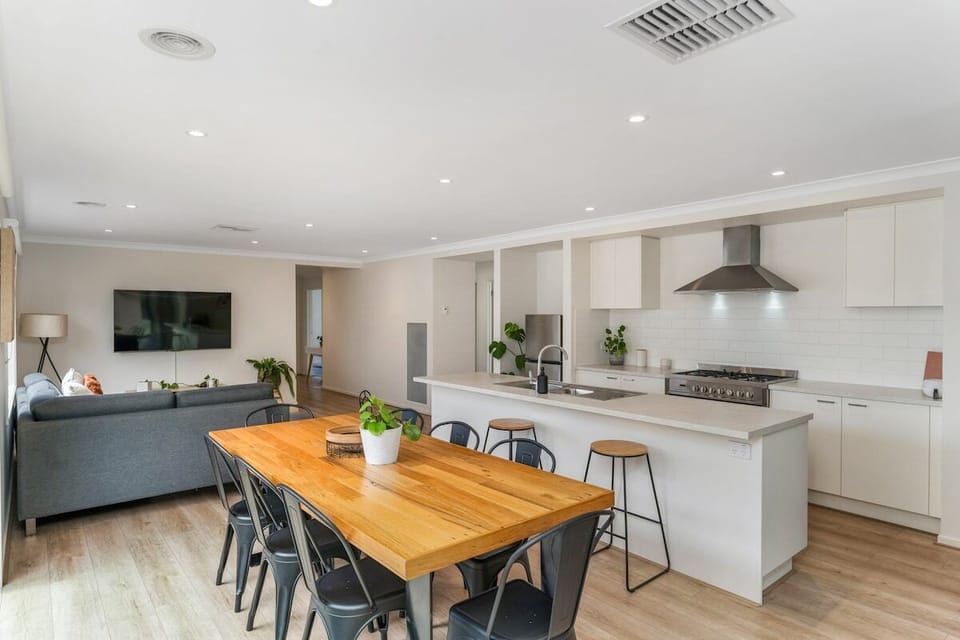 Open plan living, dining and kitchen with enough space for up to 8 guests.