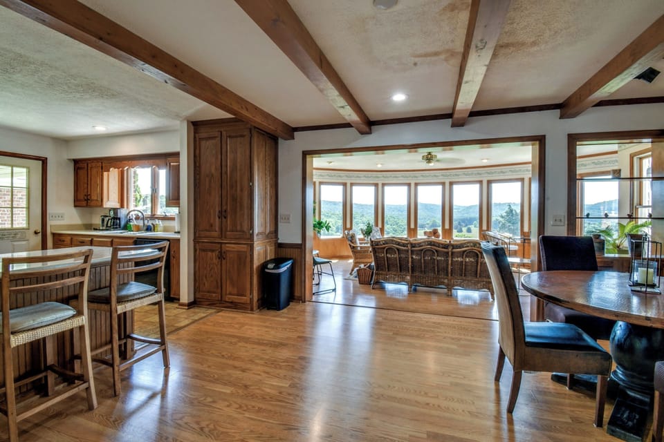 Kitchen to the left, sunroom in the middle, dining area to the right.