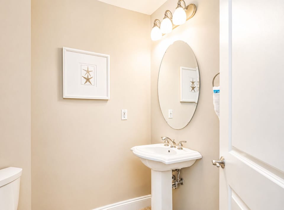 Step into your elegantly appointed powder room with stylish pedestal sink and warm lighting for comfortable morning routines.