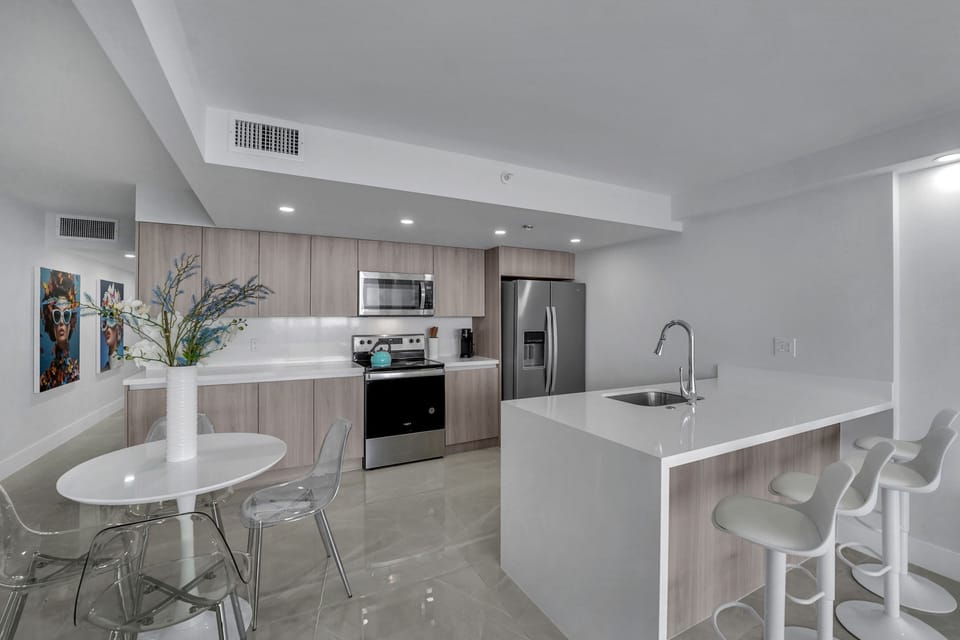 Fully equipped kitchen with seating for 4 at kitchen counter and seating for 4.