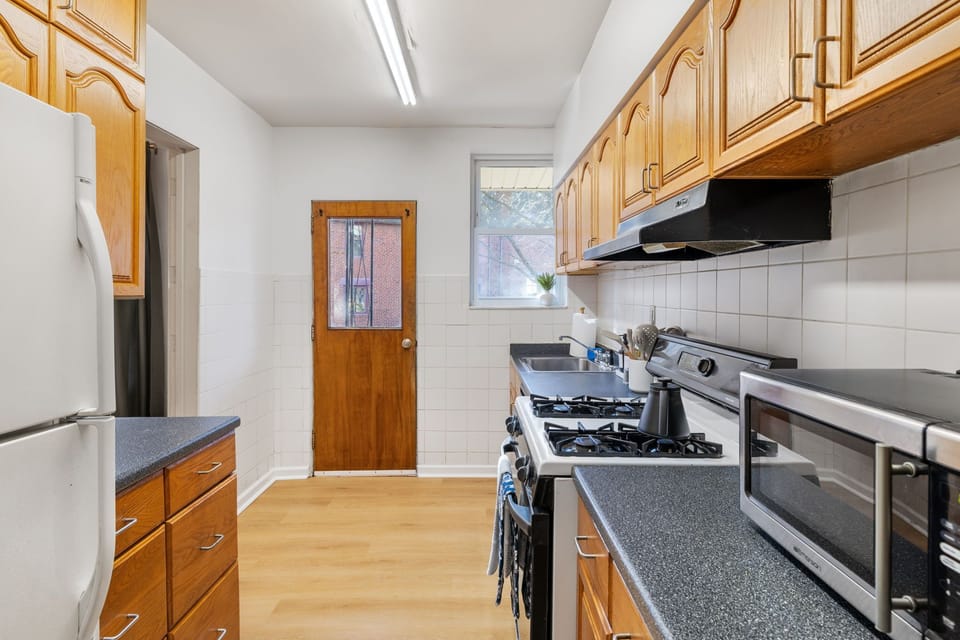 Well-equipped kitchen featuring a stove with a sleek range hood