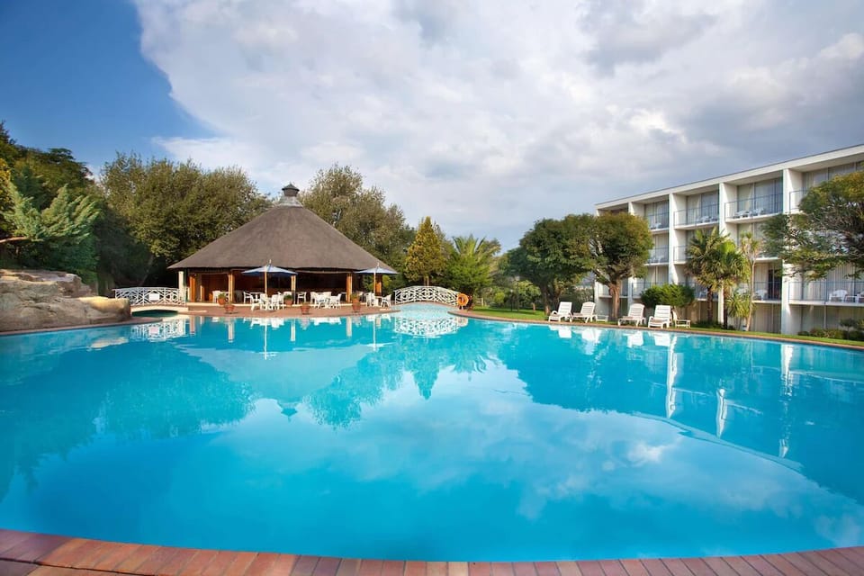 Dive into a sparkling pool beside the relaxed thatched pavilion.