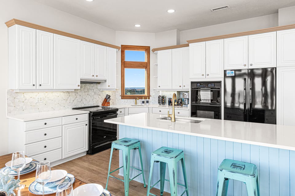 Bright and modern kitchen with white cabinets and a stylish island.