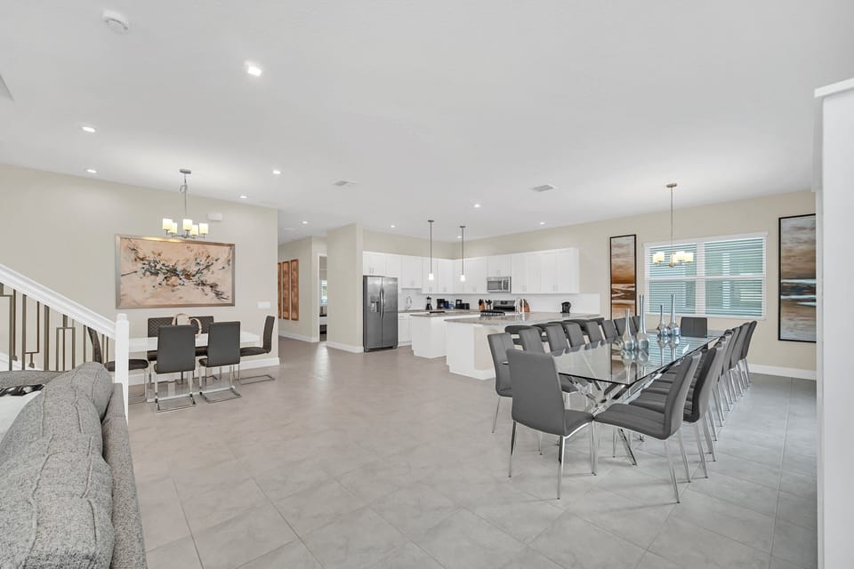 Entryway and open kitchen view featuring granite counters, wood cabinetry, and a breakfast bar.