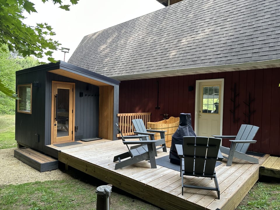 Sauna, outdoor bathtub and sitting area behind the main house.