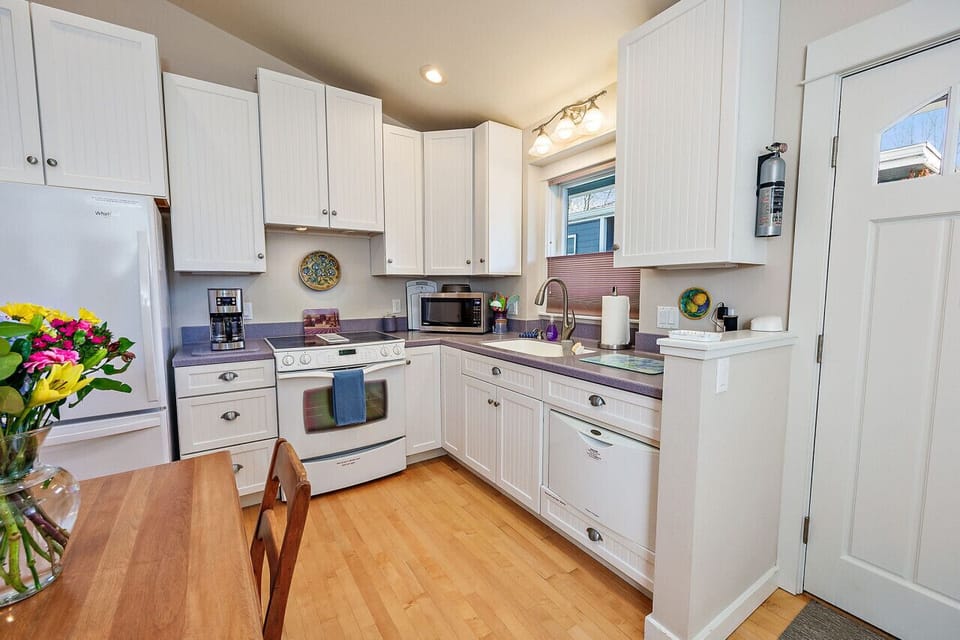 Full kitchen with electric stovetop, dishwasher, and many other appliances
