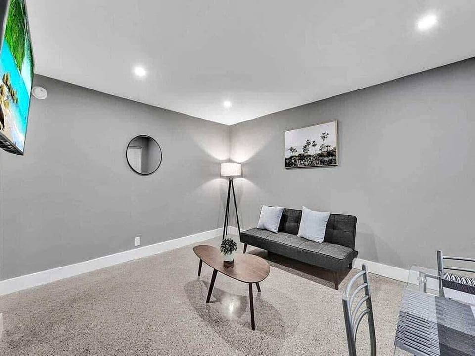 Living area with wall-mounted TV and sofa