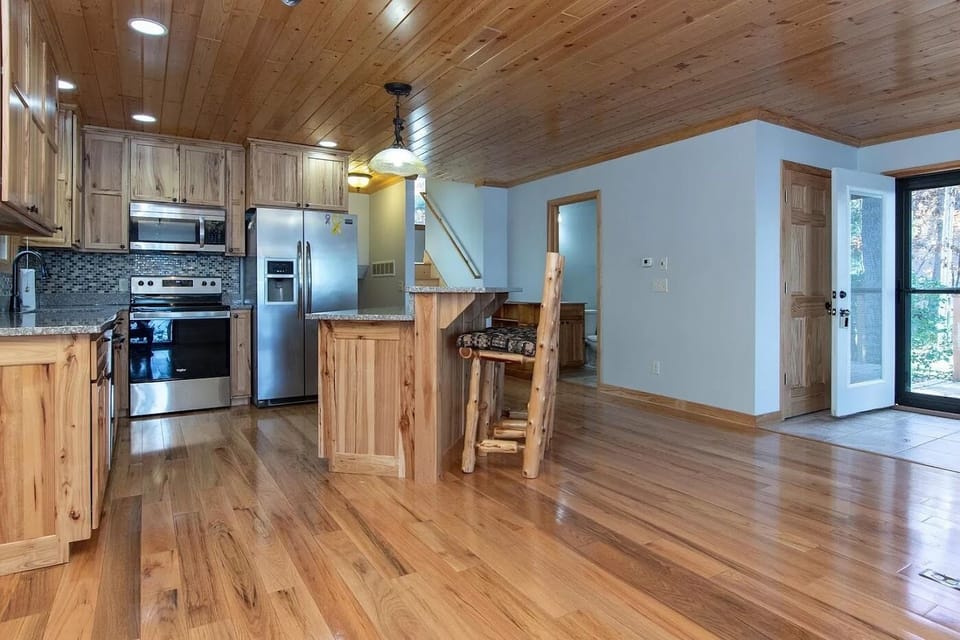 Open floor plan of living, dining and kitchen with one full bath off kitchen.