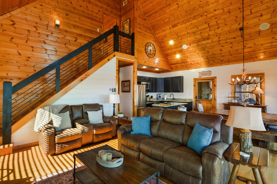Open concept family space with staircase leading to mater bedroom 