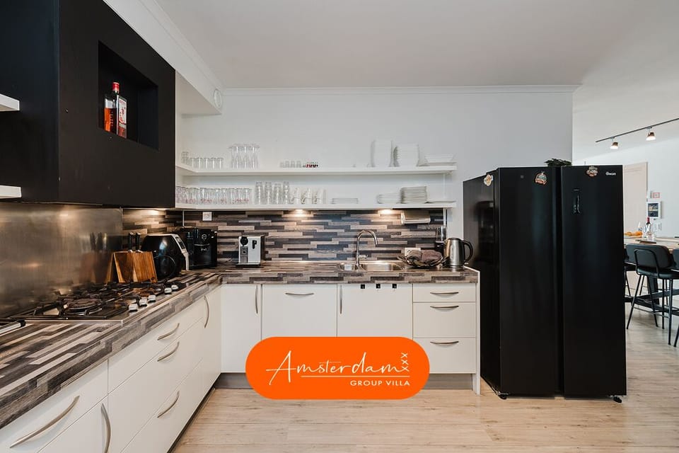 The kitchen includes two ovens, a microwave, a dishwasher, and a coffee machine.
