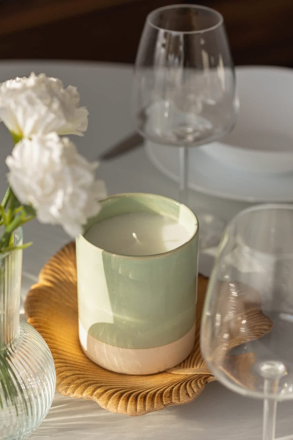 Table setting with elegant glassware, cup, and decorative details.
