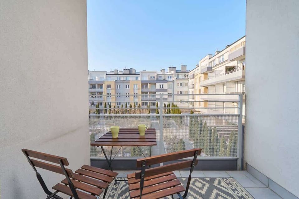 Balcony with seating area and city view.
