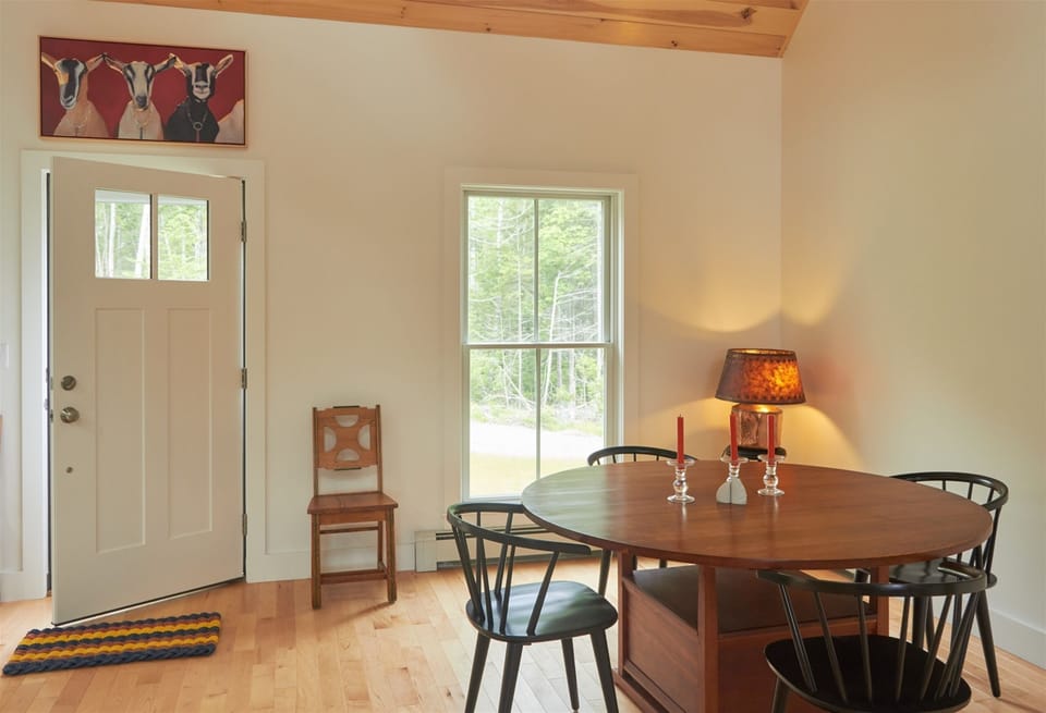dining table and front door with Goat Picture above door