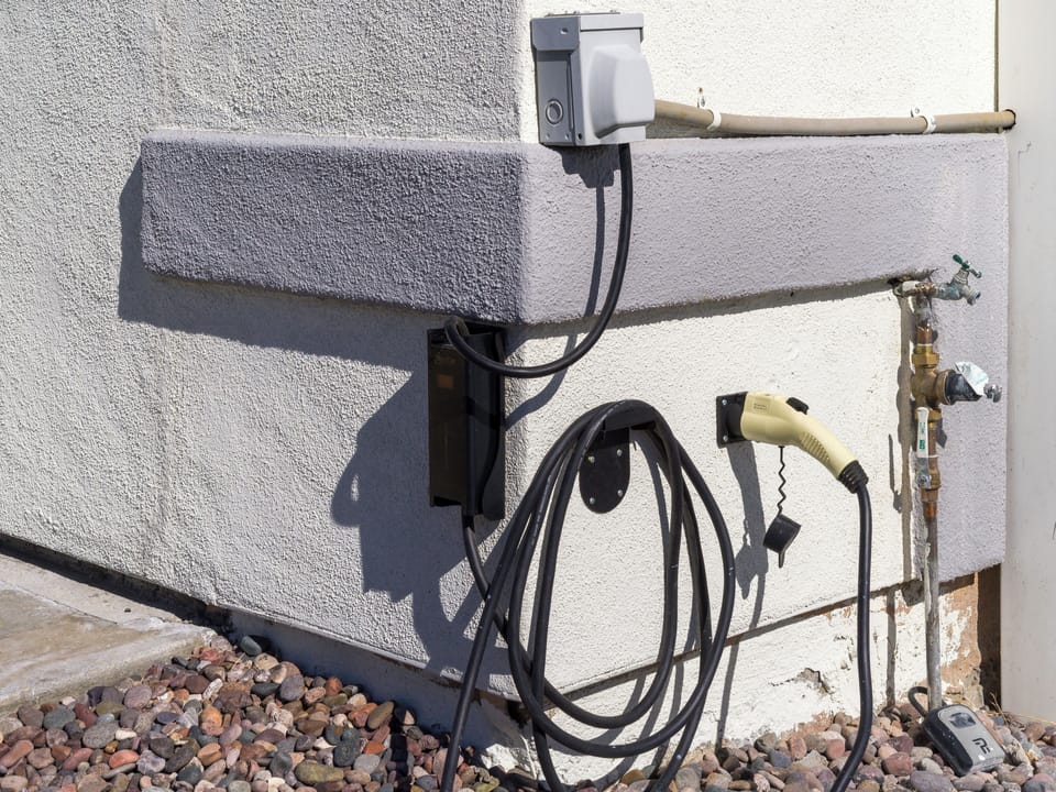 EV charger with optional Tesla adapter.