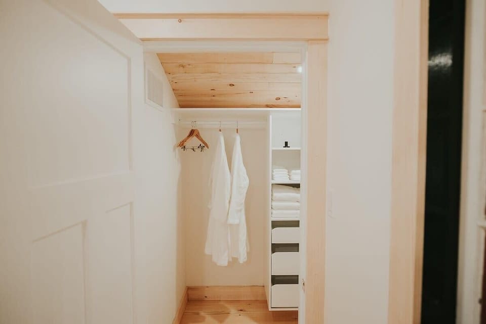 Walk in master closet with complimentary robes 