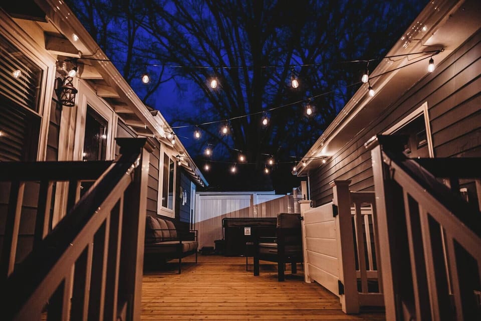 Tranquil private deck with hot tub and towel rack.