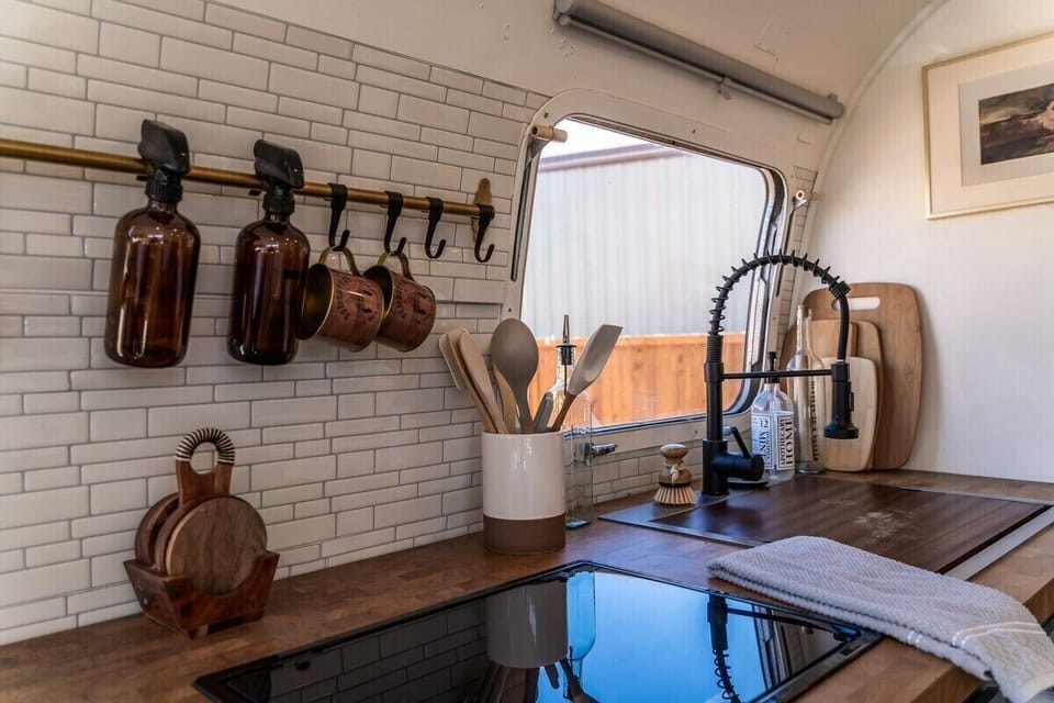 Nicely equipped kitchen with a chic decor seamlessly integrated within a charming, vintage frame.