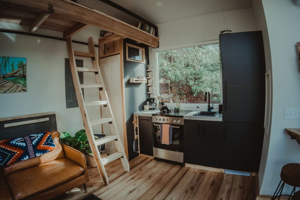 A bright, open layout with full kitchen and lofted sleeping area.