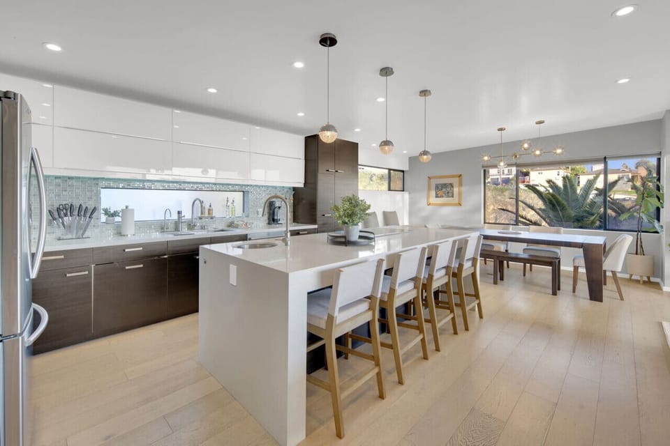 Modern Kitchen with Dining Area: Enjoy cooking with sleek appliances and vibrant natural light!