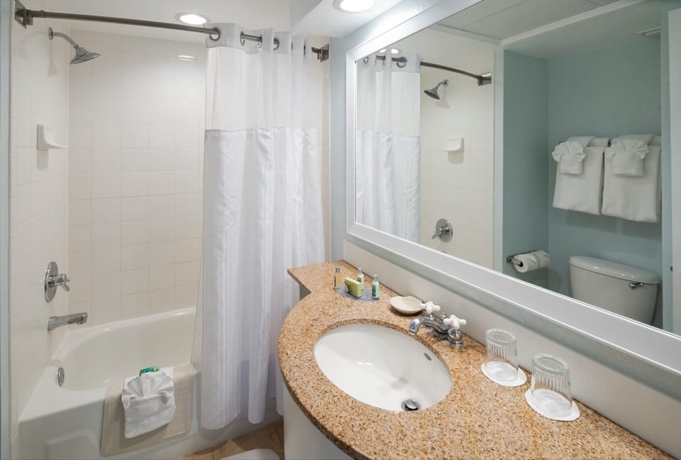 Step into a bright bath with roomy vanity and shower.