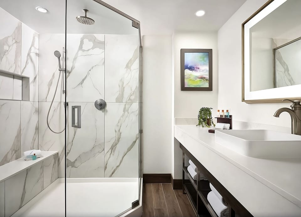 Step into a glass walk-in shower for a fresh start.