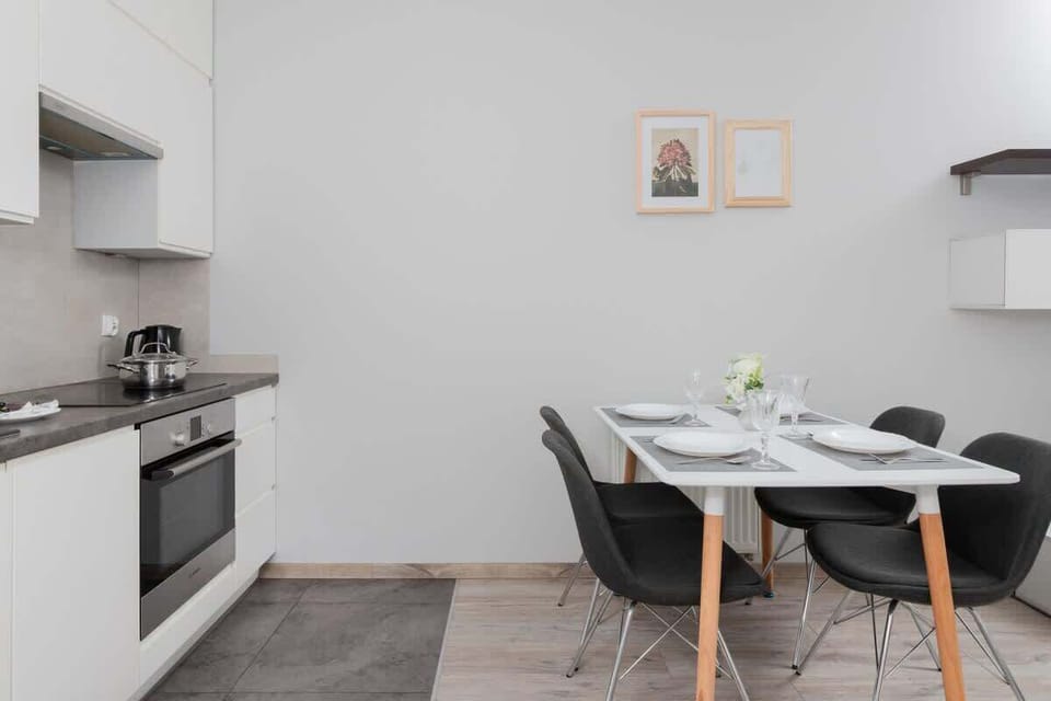 Open-plan kitchen and dining area with modern furniture and neutral tones.
