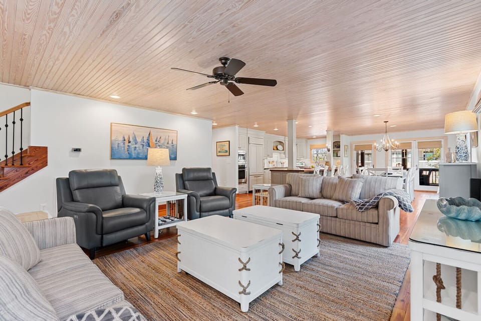 Relax in your spacious living room with comfy seating, nautical charm, and an open layout perfect for gathering.