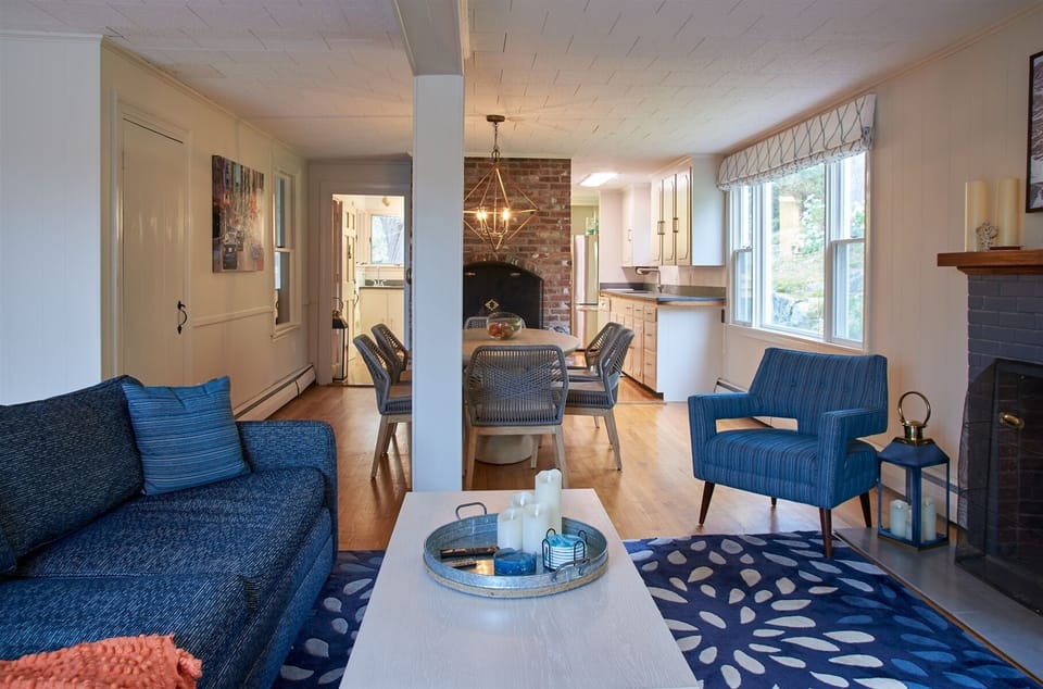 main sitting room with dining table leading into kitchen