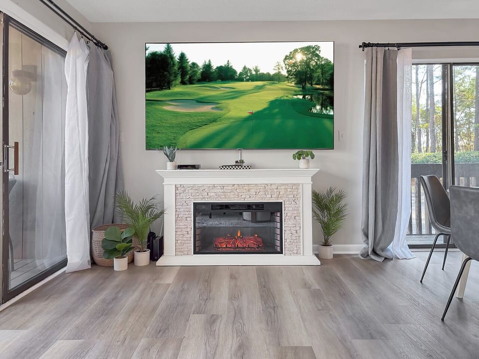 Living area with electric fireplace and brand new, oversized flat screen TV