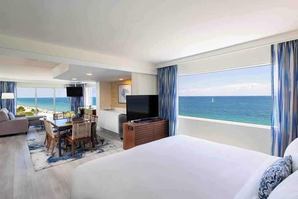Wake up to panoramic ocean views in a bright suite.