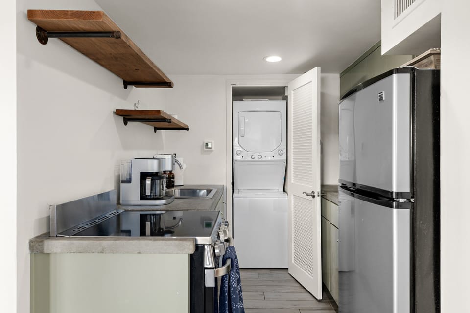 Compact and functional Kitchen offering a hidden Laundry Area with all Laundry appliances.