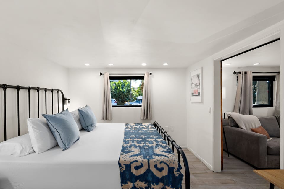 Bright and inviting Bedroom retreat with a King-size Bed, plush linens, and stylish décor. Large window with natural light and garden views. Sliding door for Privacy while maintaining an open flow
