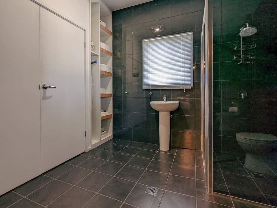 The first ensuite: walk-in shower, basin and toilet