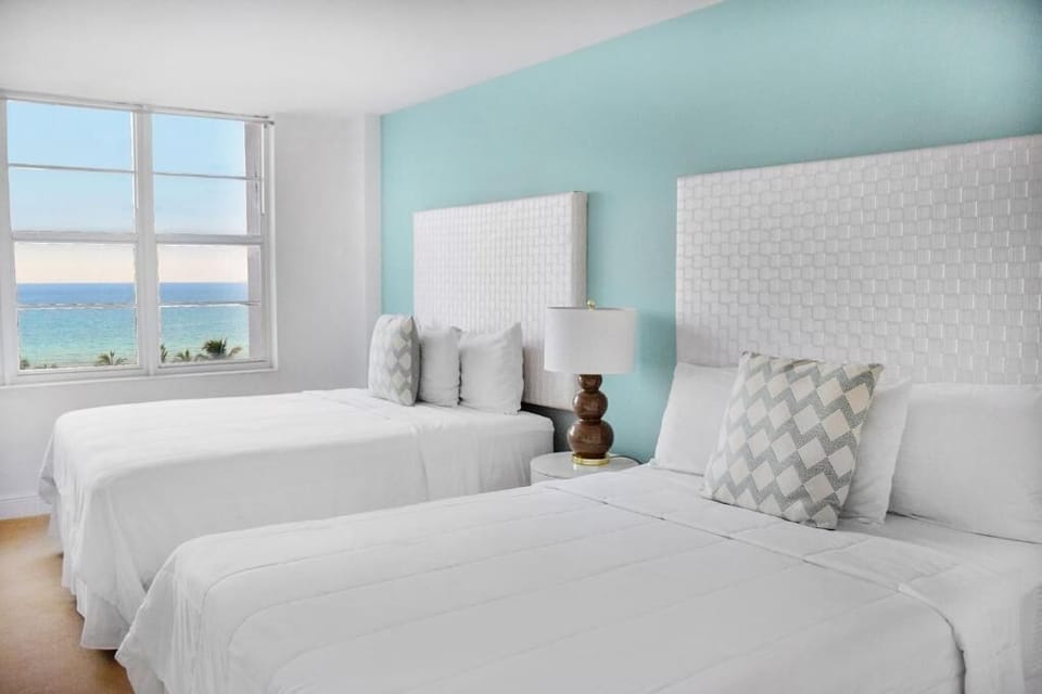 Drift off in twin beds with calming coastal light.