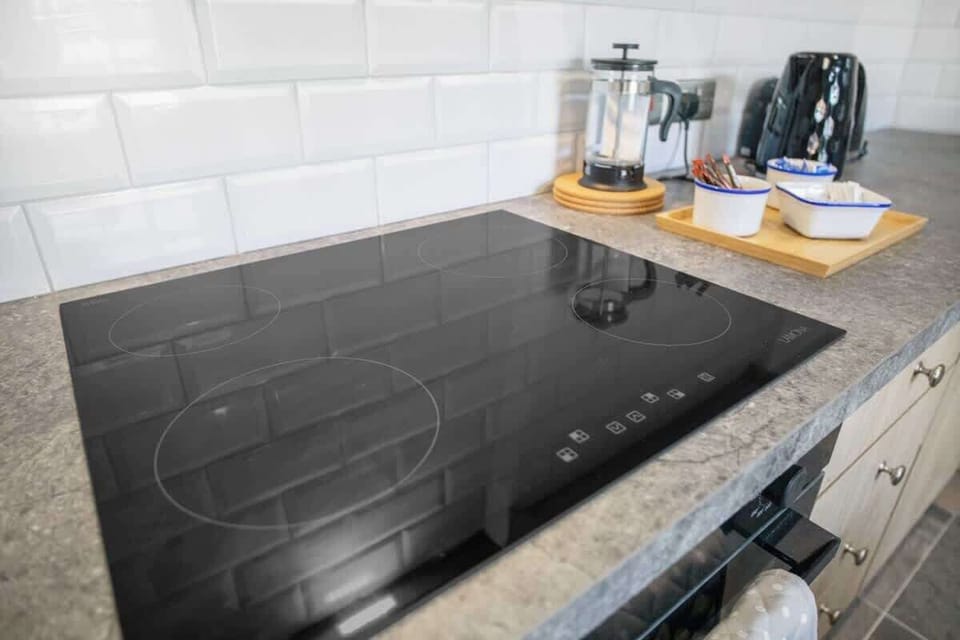 Kitchen equipped with all essentials, including a washer & dryer, oven, fridge and full cookware set.